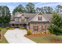 Beautiful exterior of craftsman-style home with stone accents, shutters, and a well-manicured lawn at 6329 Granbury Walk, Acworth, GA 30101
