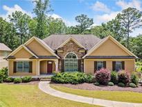 Charming one-story home with stone accents, manicured landscaping, and a welcoming walkway at 212 Wilshire Ter, White, GA 30184