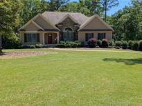 Charming single-story home featuring stone accents and a well-manicured lawn at 212 Wilshire Ter, White, GA 30184