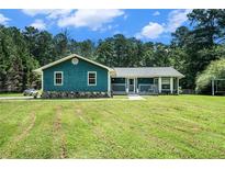 Charming single story home with a covered front porch and beautifully maintained lawn at 2969 White Ne Rd, Conyers, GA 30012