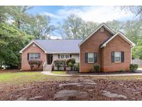 Charming brick home with well-maintained landscaping and inviting entrance at 210 Riveredge Way, Mcdonough, GA 30252