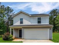 Charming two-story home featuring a two-car garage and well-maintained front yard and appealing color scheme at 20 Sloane Ct, Covington, GA 30016