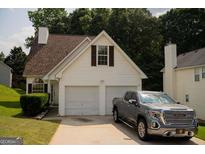Charming home with a two-car garage and well-manicured lawn at 3269 N Winds N Trl, Douglasville, GA 30135