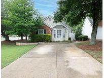 Charming home with a well-manicured lawn, beautiful trees, and a welcoming front exterior at 2790 Barnwood Xing, Duluth, GA 30097