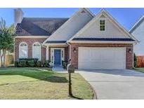 Charming one story brick home with a well manicured lawn, two-car garage, and inviting blue front door at 2163 Berryhill Se Cir, Smyrna, GA 30082