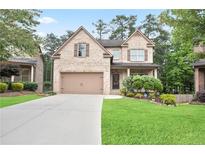 Charming two-story brick home with a well-maintained lawn and a two-car garage at 2720 Tuscany Park Dr, Lawrenceville, GA 30043