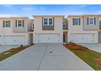 Charming townhomes with attached garages and neutral exteriors, perfect for modern living at 341 Heavenly Hollow Pl, Mcdonough, GA 30253