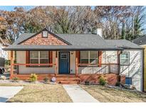 Inviting home exterior featuring a cozy porch, fresh paint, and mature landscaping in front yard at 20 S Eugenia Nw Pl, Atlanta, GA 30318