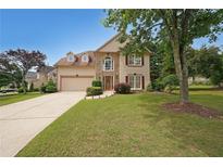 Charming two-story home with a well-manicured lawn, mature trees, and a two-car garage at 2747 Harper Woods Dr, Marietta, GA 30062
