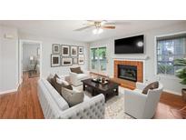 Bright living room with hardwood floors, fireplace, and access to a private deck at 514 Mcgill Ne Pl, Atlanta, GA 30312