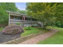 Charming home with a welcoming front yard, landscaped garden, and a brick pathway to the entrance at 5770 Dorsett Shoals Rd, Douglasville, GA 30135