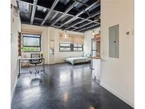 Open floor plan featuring high ceilings, large windows, and modern industrial design elements at 878 Ne Peachtree Ne St # 326, Atlanta, GA 30309