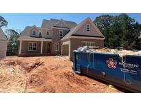 New brick home construction with gray trim, new windows, and a large blue Republic Services dumpster at 2753 S Waterworks Rd, Buford, GA 30518