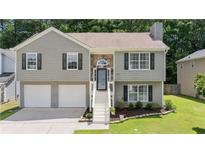 Charming two-story home featuring an attached two-car garage and a well-maintained front yard at 1087 Berkley Se Dr, Smyrna, GA 30082