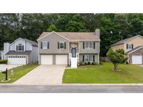 Charming two-story home featuring a well-maintained lawn and inviting front entrance at 1087 Berkley Se Dr, Smyrna, GA 30082