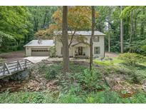 Beautiful home with a charming bridge leading to the front yard, nestled in a lush, green environment at 82 Vanessa Se Dr, Smyrna, GA 30082