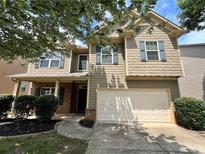 Inviting two-story home features a two-car garage, neutral siding, and charming curb appeal at 3522 Fallen Oak Dr, Buford, GA 30519