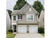 Charming two-story home with a two-car garage, neutral siding and a well-maintained lawn at 303 Barberry Pl, Canton, GA 30114