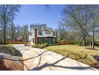 Beautiful two-story home boasts modern design, lush lawn, and a long, private driveway at 3087 Alston Dr, Decatur, GA 30032