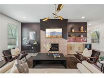 Inviting living room with a fireplace, bar area, stylish light fixture, and comfortable seating at 3087 Alston Dr, Decatur, GA 30032