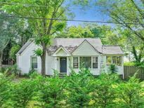 Charming one story brick home with mature trees and inviting front yard landscaping at 511 Ashburton Ave, Decatur, GA 30032