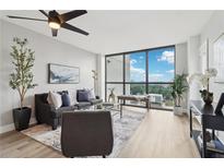 Bright living room featuring a ceiling fan, a large window with a view, and modern decor at 1280 W Peachtree Nw St # 2205, Atlanta, GA 30309