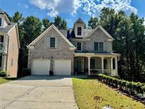 Charming two-story brick home with a well-manicured lawn and a welcoming front porch at 2822 Salem Oak Way, Duluth, GA 30096