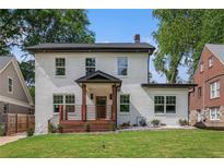 Charming two-story home featuring a welcoming front porch and manicured lawn on a sunny day at 1721 S Gordon Sw St, Atlanta, GA 30310