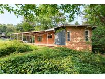 Charming brick home with a covered patio and lush, green landscaping at 3861 Foxford Dr, Atlanta, GA 30340