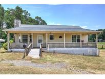 Charming single-story home featuring a cozy front porch and well-maintained landscaping at 668 Spring Place Ne Rd, White, GA 30184
