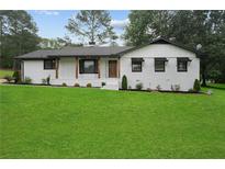Charming one-story home with a beautifully landscaped front yard, updated with black accents at 2827 Highway 138 Ne, Conyers, GA 30013
