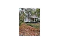 Charming single story home with a covered porch and surrounded by greenery at 3400 North Fulton Ave, Hapeville, GA 30354