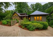 Inviting front yard with lush landscaping and a charming bridge leading to the stone and wood facade home at 1757 E Clifton Ne Rd, Atlanta, GA 30307