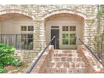 Inviting front entrance featuring brick stairs, stone archway, and well-maintained landscaping at 625 Piedmont Ne Ave # 105, Atlanta, GA 30308