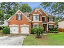 Charming two-story brick home with a well-manicured lawn and a two-car garage at , Atlanta, GA 30360