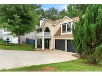 Charming two-story home with a welcoming front porch and attached two-car garage at 1086 Erie Cir, Stone Mountain, GA 30087