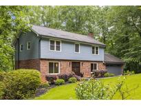 Charming two-story home with a well-manicured lawn, brick accents, and attached two car garage at 2892 Guinevere Ne Dr, Atlanta, GA 30345