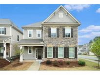 Charming two-story home featuring a stone facade, landscaped front yard, and inviting front porch at 3514 Ambassador Aly, Scottdale, GA 30079