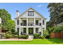 Charming two-story home with a welcoming front porch and manicured lawn at 560 Morgan Ne St, Atlanta, GA 30308
