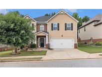 Charming two-story home featuring a two-car garage and well-manicured front lawn at 316 Sierra Ct, Mcdonough, GA 30253