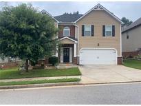 Charming two-story home featuring a manicured front lawn and a two-car garage at 316 Sierra Ct, Mcdonough, GA 30253