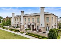 Charming brick townhomes featuring private patios and beautifully manicured landscaping at 132 Grand Cres, Alpharetta, GA 30009