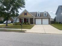 Charming single-Gathering home featuring double garage, manicured front yard and welcoming front porch at 4200 Vinca Way, Union City, GA 30291