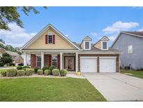 Charming single-Gathering home with a well-manicured lawn, two-car garage, and red shutters at 4200 Vinca Way, Union City, GA 30291
