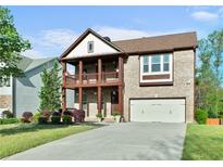 Charming two-story brick home with a double porch and two car garage at 1610 Apollo Dr, Suwanee, GA 30024