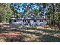 Charming, newly renovated single-story home featuring a white brick facade and a lush front yard at 380 Inman Rd, Fayetteville, GA 30215