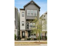 Charming three-story home features a black metal fence, balcony, and a combination of siding and brick at 522 Hargrove Ln, Decatur, GA 30030