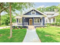 Charming home showcasing a well-manicured lawn, quaint porch, and blue exterior at 1253 Lucile Sw Ave, Atlanta, GA 30310