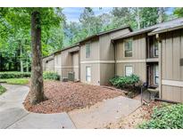 Charming townhome featuring a well-maintained lawn, mature trees and a serene, wooded setting at 8740 Roswell Rd # 2G, Atlanta, GA 30350