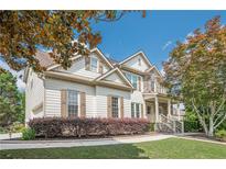 Charming two-story home with stone accents, manicured lawn and inviting front porch at 113 Gold Bridge Xing, Canton, GA 30114